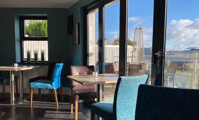 Dining tables with a sea view at the Belmont Hotel.